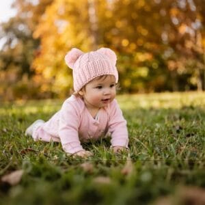 Warm knitted baby beanie with soft pom pom for infants