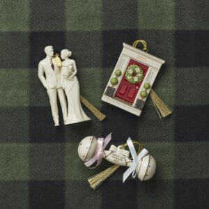 “Lenox 2025 Baby’s First Christmas ornament hanging on winter tree décor.”